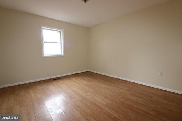 spare room featuring light wood-type flooring