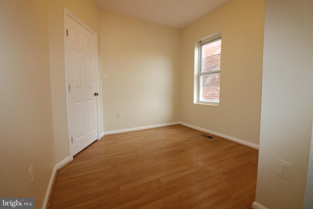 empty room featuring wood-type flooring