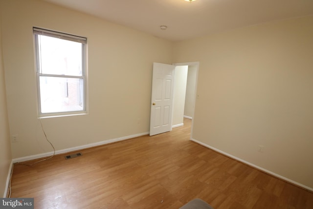 unfurnished room with light wood-type flooring