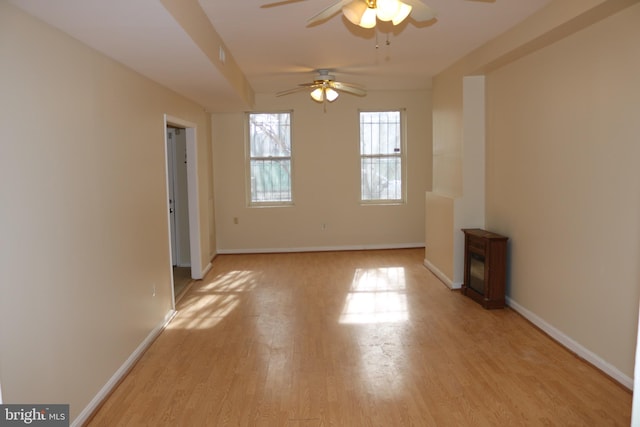 unfurnished living room featuring ceiling fan and light wood-type flooring