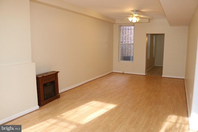 unfurnished living room featuring ceiling fan and light hardwood / wood-style flooring