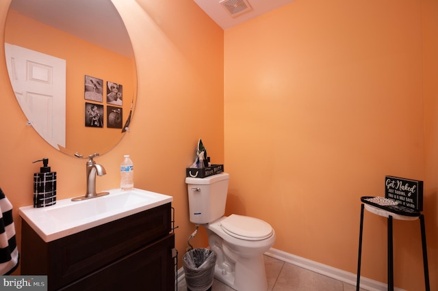 bathroom featuring tile patterned flooring, vanity, and toilet