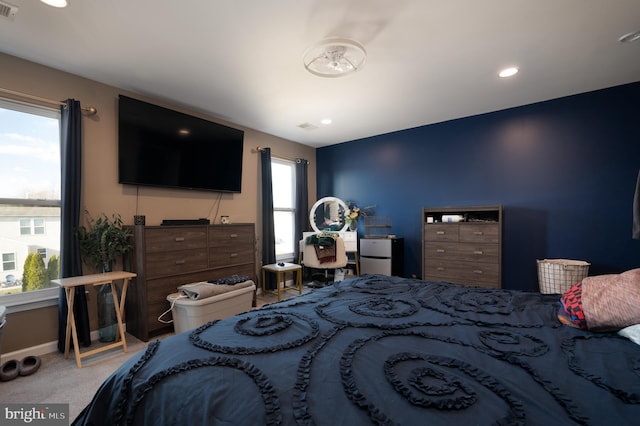 carpeted bedroom featuring multiple windows