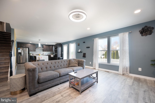 living room with light hardwood / wood-style flooring