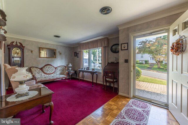 living room with ornamental molding and light parquet flooring