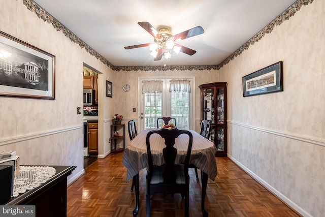 dining room featuring ceiling fan and dark parquet flooring