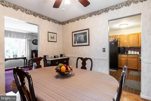 dining space featuring ceiling fan and light parquet floors