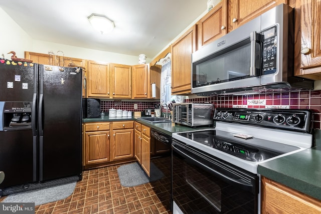 kitchen featuring black appliances, sink, and backsplash