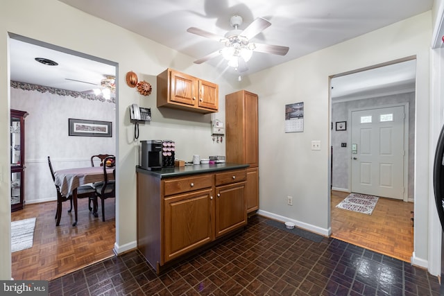 kitchen with dark parquet floors and ceiling fan