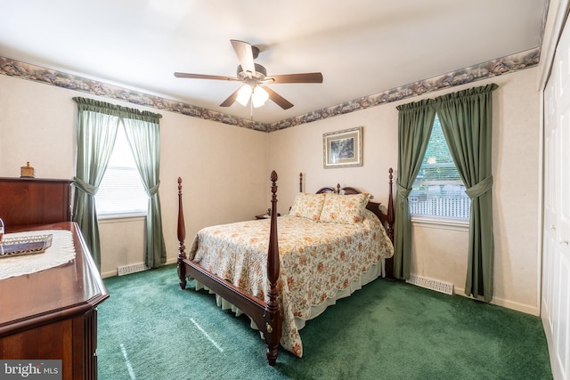 bedroom featuring dark colored carpet, a closet, and ceiling fan