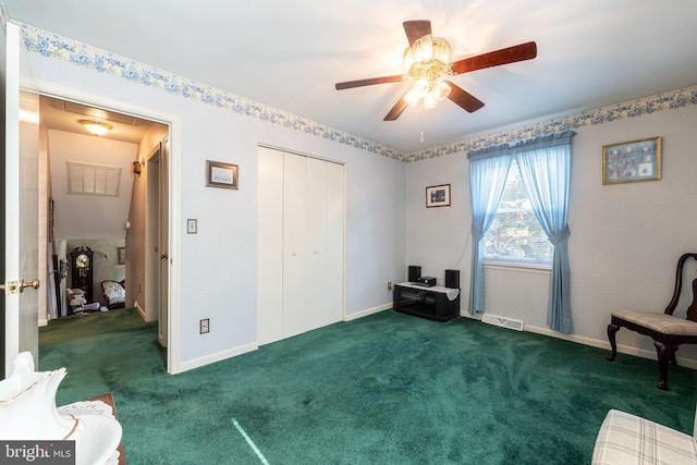 unfurnished room featuring dark carpet and ceiling fan