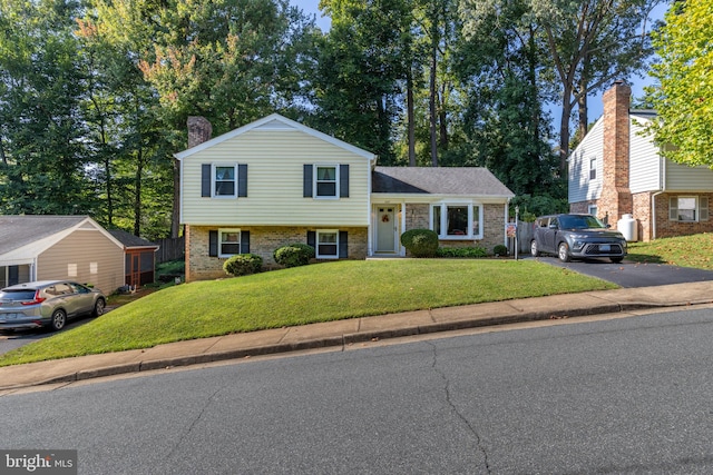 split level home with a front lawn