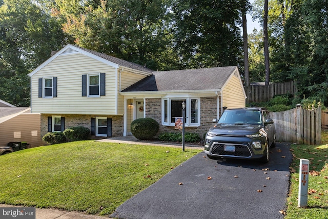 split level home featuring a front lawn