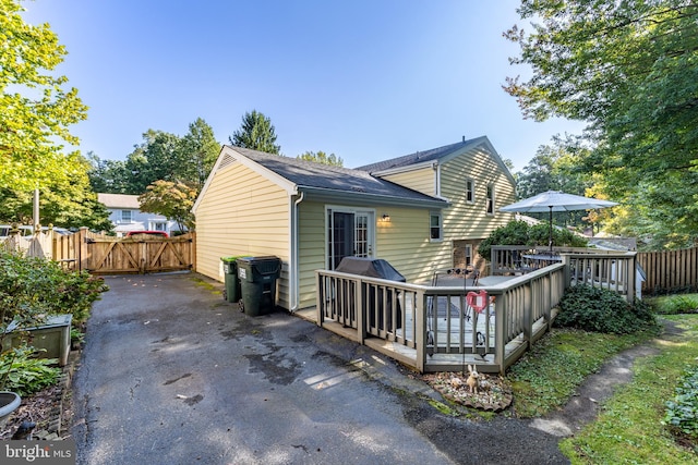 back of house featuring a wooden deck