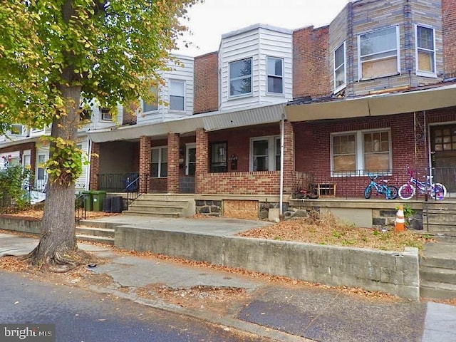 multi unit property featuring covered porch and cooling unit