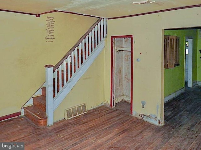 stairs featuring wood-type flooring