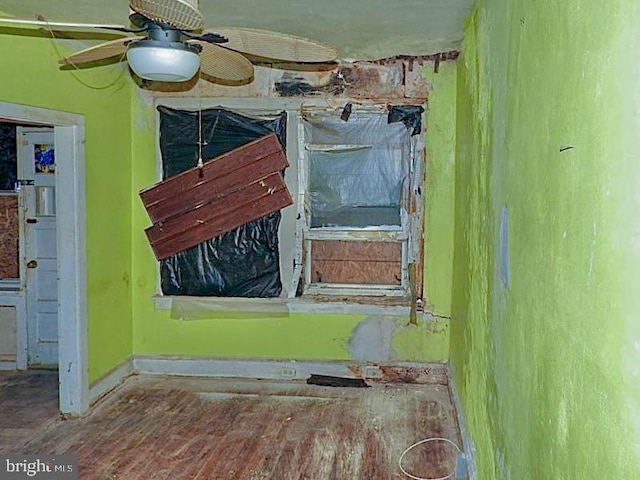 interior space with ceiling fan and wood-type flooring