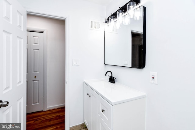 bathroom with vanity and hardwood / wood-style flooring