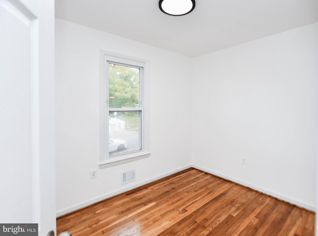 empty room with wood-type flooring