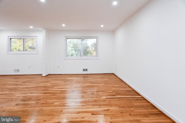 spare room with a healthy amount of sunlight and light wood-type flooring