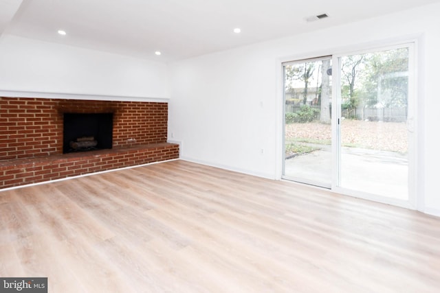 unfurnished living room with light hardwood / wood-style flooring and a fireplace