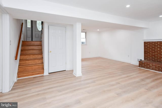 basement with light hardwood / wood-style floors