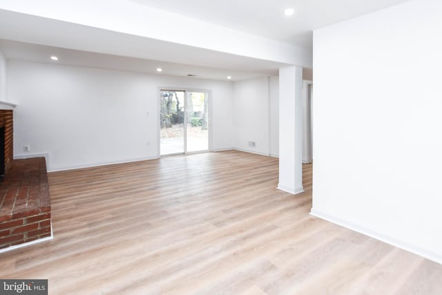 unfurnished living room with light hardwood / wood-style flooring and a fireplace