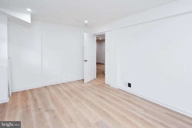 spare room featuring light wood-type flooring