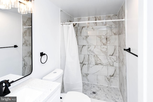 bathroom with vanity, curtained shower, and toilet