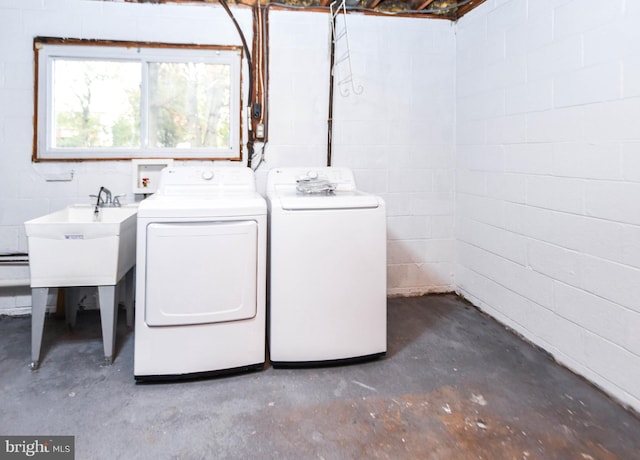 clothes washing area featuring sink and washing machine and clothes dryer