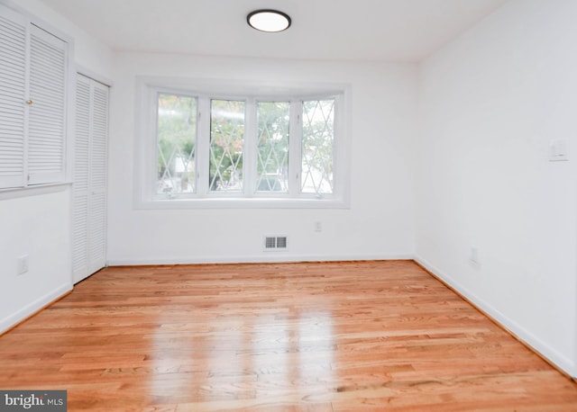 spare room featuring light hardwood / wood-style floors