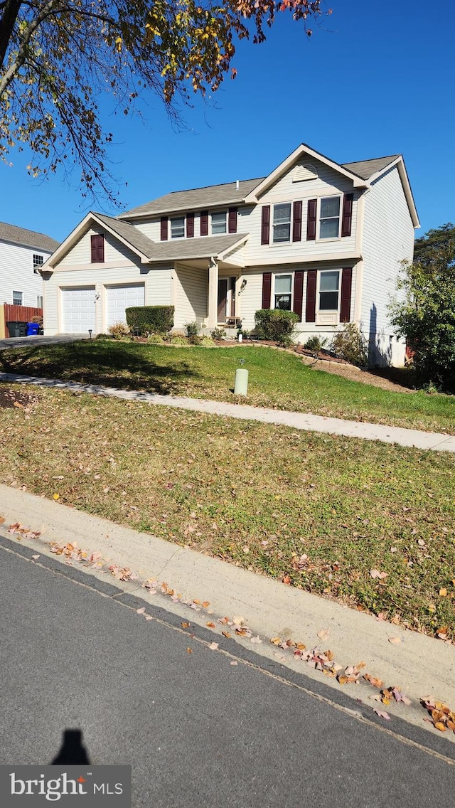 view of front of home featuring a garage and a front yard