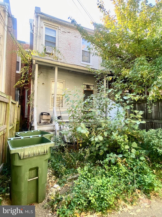 rear view of house featuring cooling unit