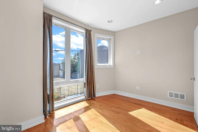 unfurnished room with light hardwood / wood-style flooring