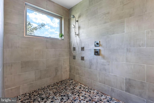 bathroom with a tile shower