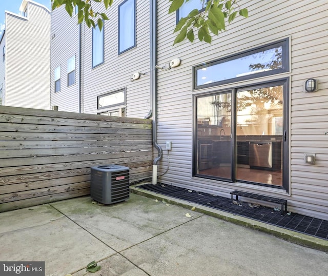 view of side of home featuring central AC and a patio area