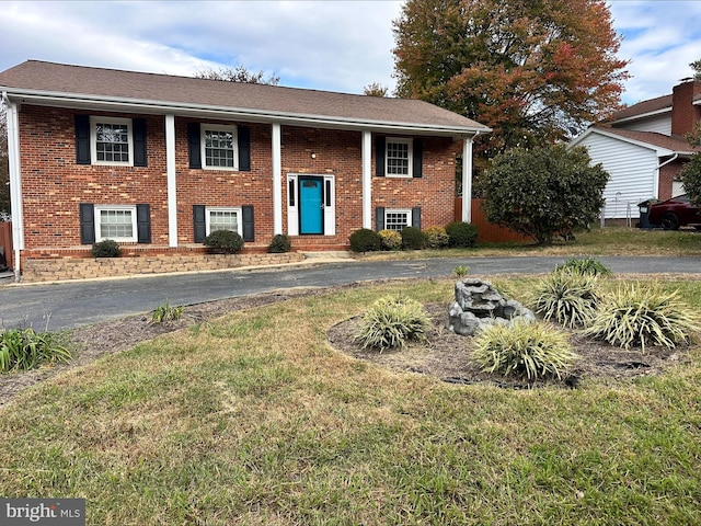 raised ranch with a front lawn