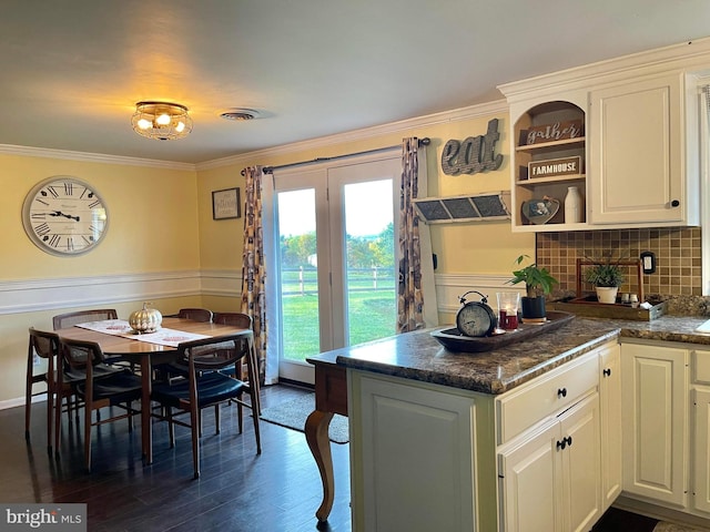 kitchen featuring crown molding, tasteful backsplash, dark hardwood / wood-style floors, and white cabinets