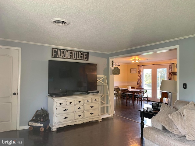 living room with crown molding, a textured ceiling, and dark hardwood / wood-style floors