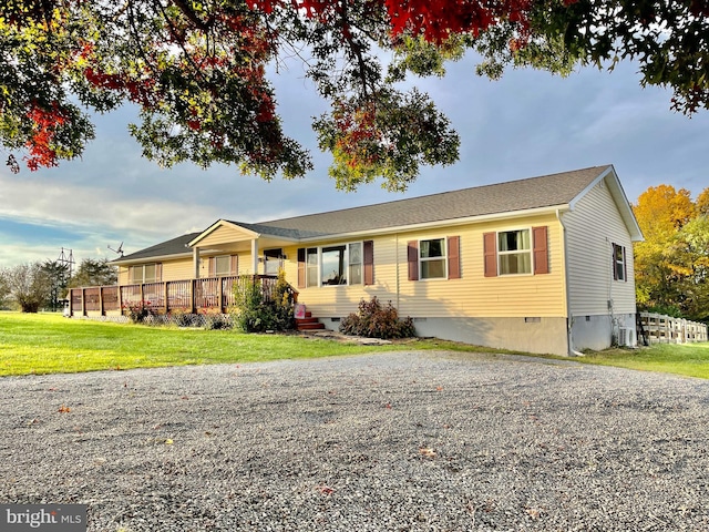 view of front of house featuring a front lawn and central AC unit