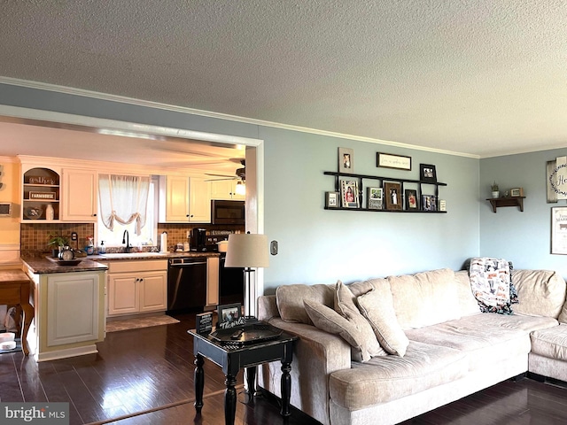 living room featuring crown molding, dark hardwood / wood-style floors, sink, and a textured ceiling