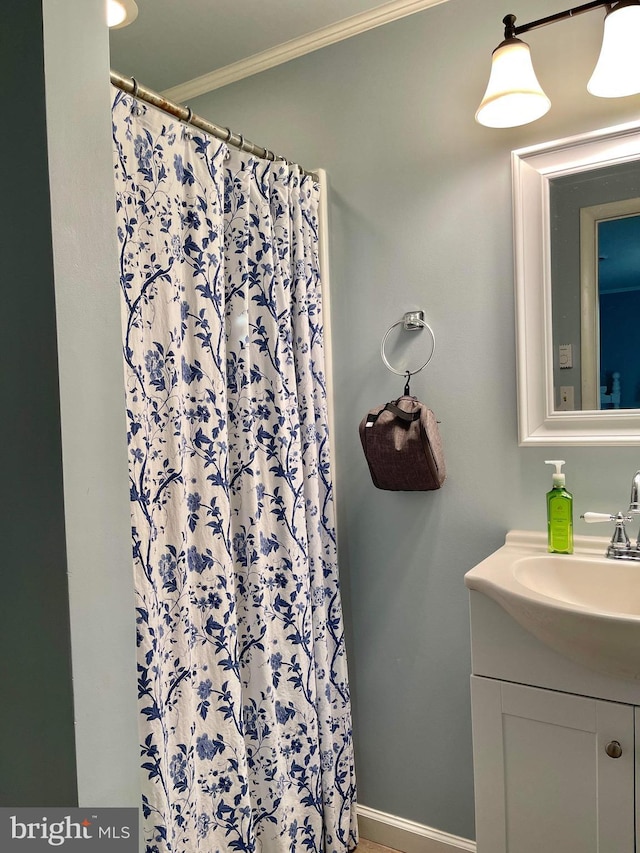 bathroom featuring vanity and ornamental molding