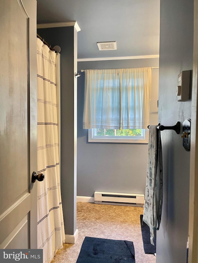 bathroom with crown molding and a baseboard radiator