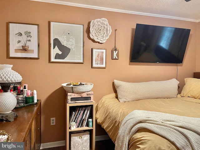 bedroom with crown molding and a textured ceiling