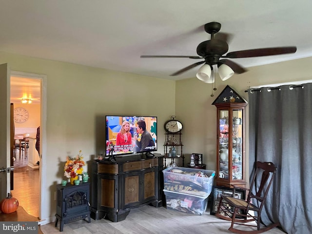 living room featuring light hardwood / wood-style floors and ceiling fan