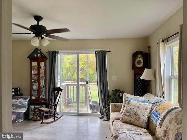 living room with ceiling fan and light hardwood / wood-style flooring