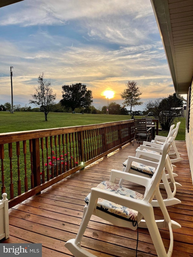 deck at dusk with a lawn