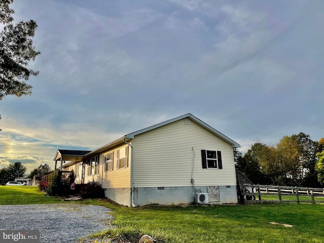 view of property exterior featuring a yard and ac unit