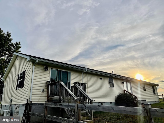 view of back house at dusk