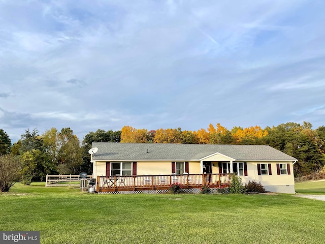 ranch-style home with a front lawn and a deck